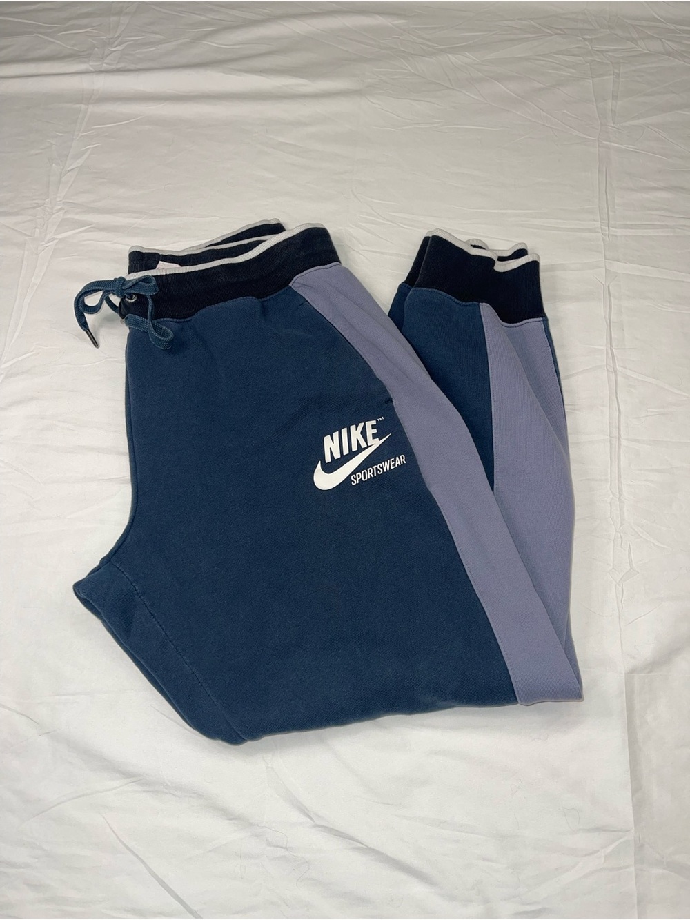 Nike jogger sweatpants, distinctive dark blue/light blue color-blocked design.